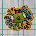 Colorful sticker with a cartoon character on a grid background