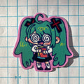 Sticker of an animated character with green hair and glasses on a grid background