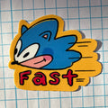 Cartoon character sticker with 'Fast' text on a grid background