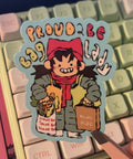 Sticker with cartoon character held over a keyboard