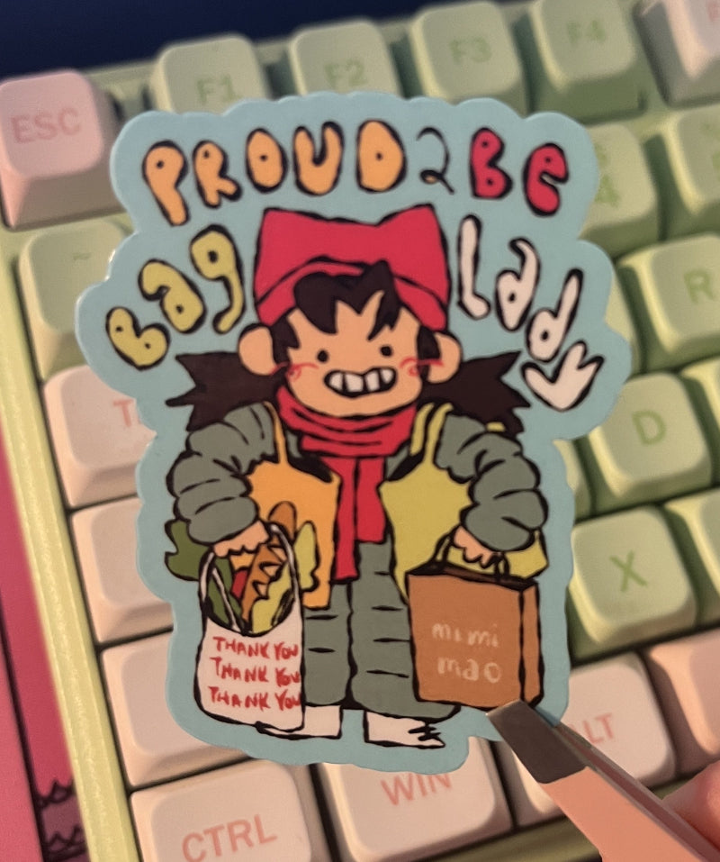 Sticker with cartoon character held over a keyboard